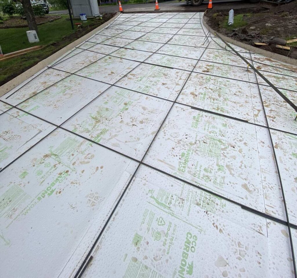 Close up of Eco Carbon branded XPS board on a slab with radiant tubing