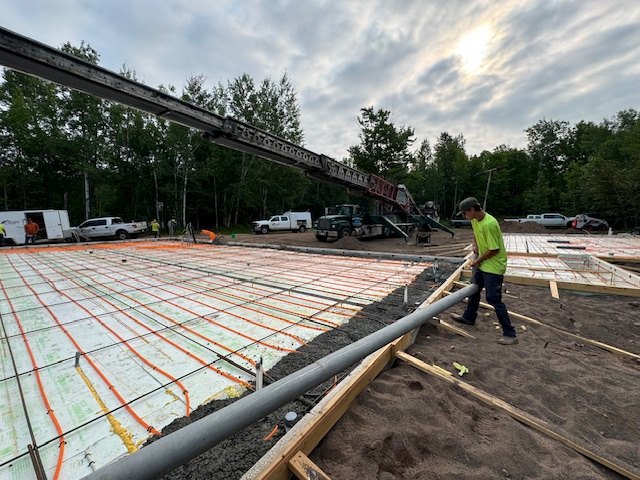 Concrete pump boom reaching over a monolithic slab insulated with Eco Foam board and formed with Eco Form